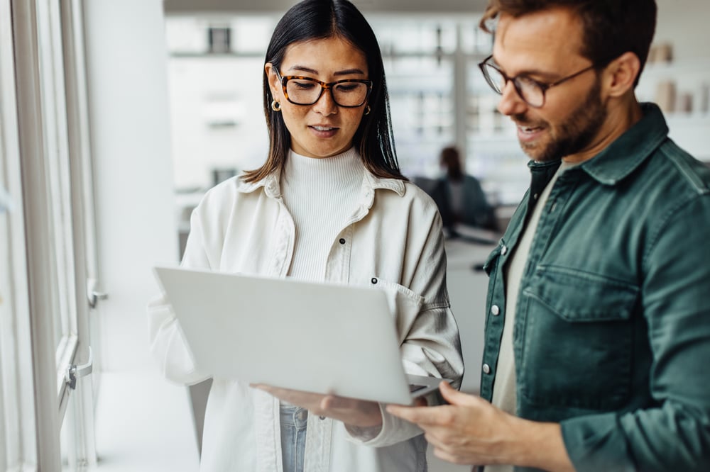 Man and woman looking at laptop